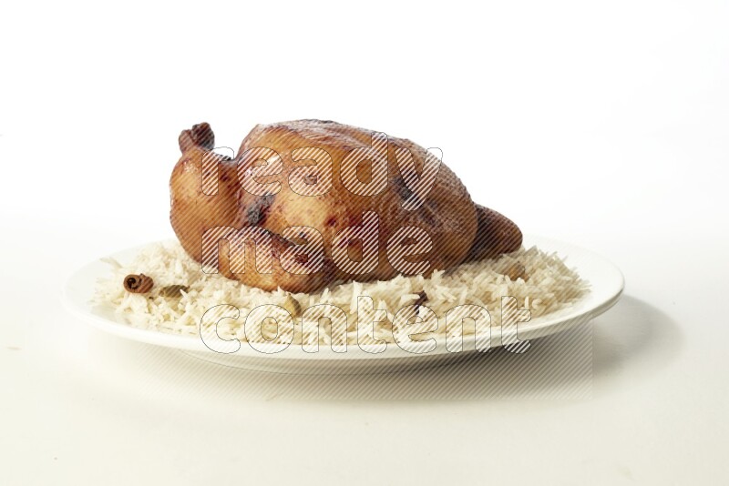 white  basmati Rice with  whole roasted chicken  on a white rounded plate direct on white background