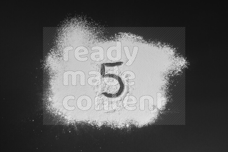 Numbers written with powder on black background