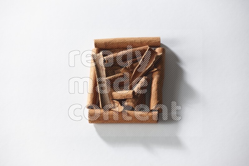 A single square of cinnamon sticks full of cinnamon on white flooring