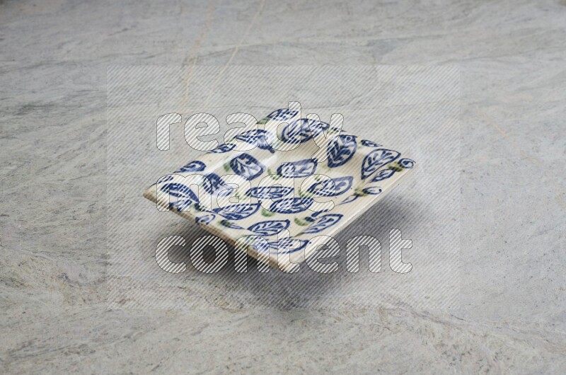 A decorative pottery plate on grey marble background