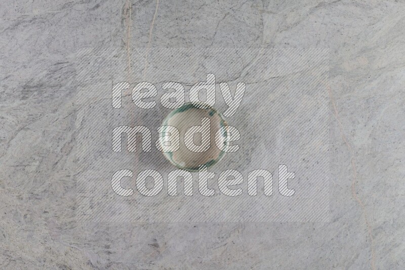 A multicolored pottery Bowl on grey marble background