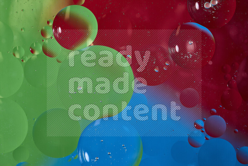 Close-ups of abstract oil bubbles on water surface in shades of blue, red and green