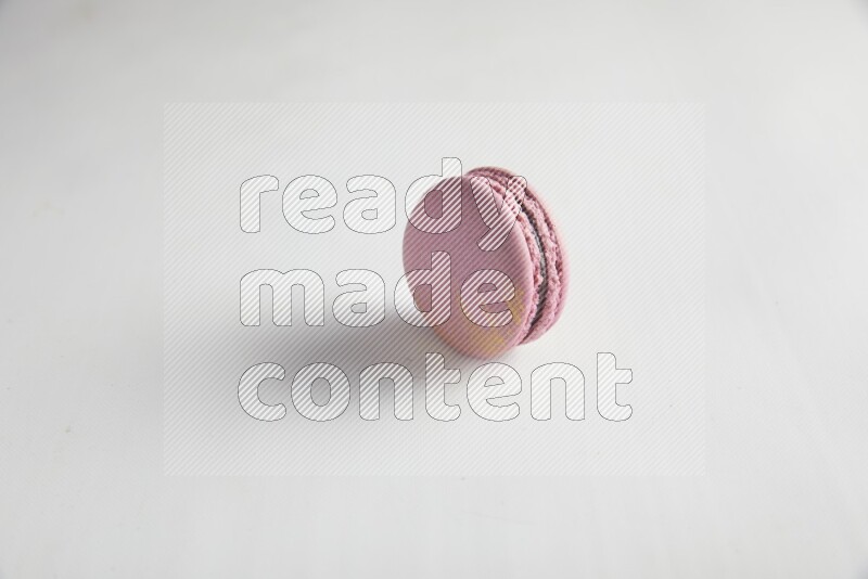 45º Shot of Purple Strawberry macaron on white background
