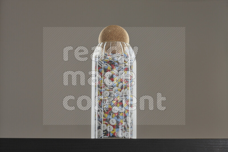 Buttons in a glass jar on black background