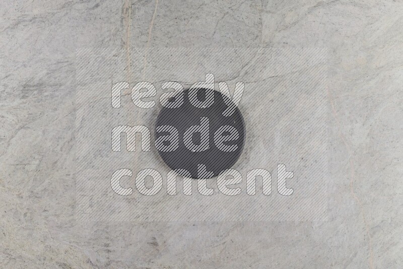 A pottery coaster on grey marble background
