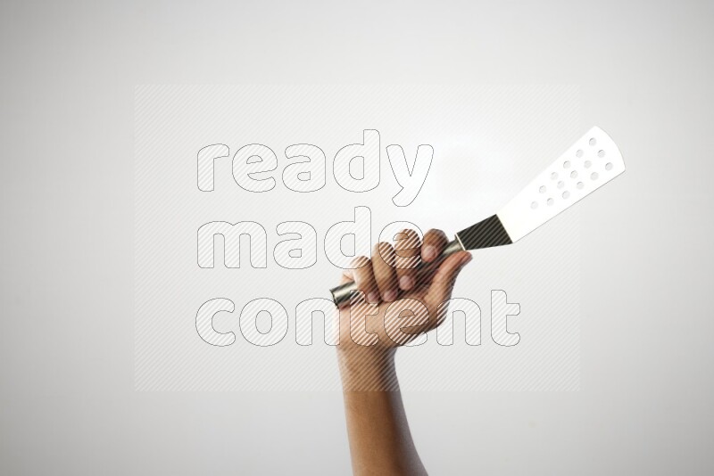 Male Hand Holding Burger Flipper on white background
