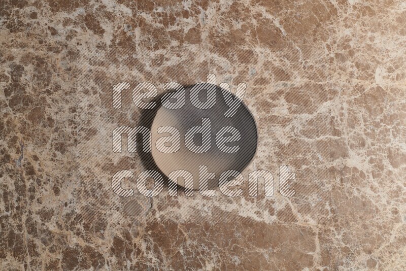 A multicolored pottery plate on beige marble background