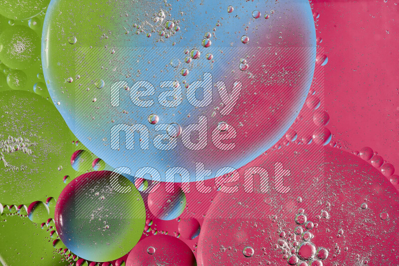 Close-ups of abstract oil bubbles on water surface in shades of pink, green and blue