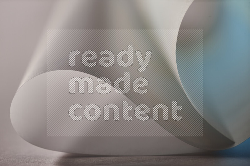 An abstract art piece displaying smooth curves in blue and grey gradients created by colored light