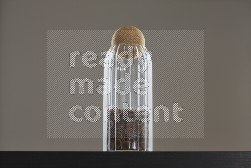Buttons in a glass jar on black background