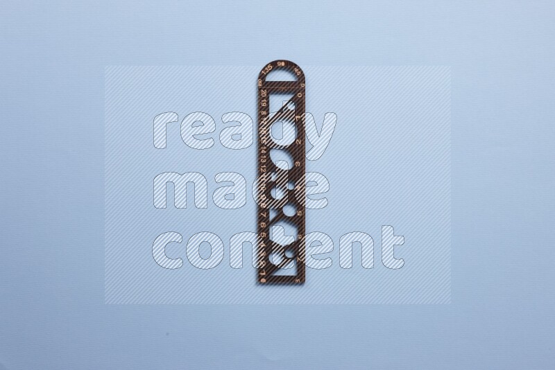 A wooden ruler on blue background