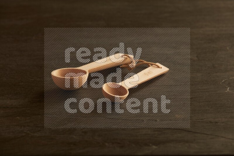 wooden spoon on black slate background