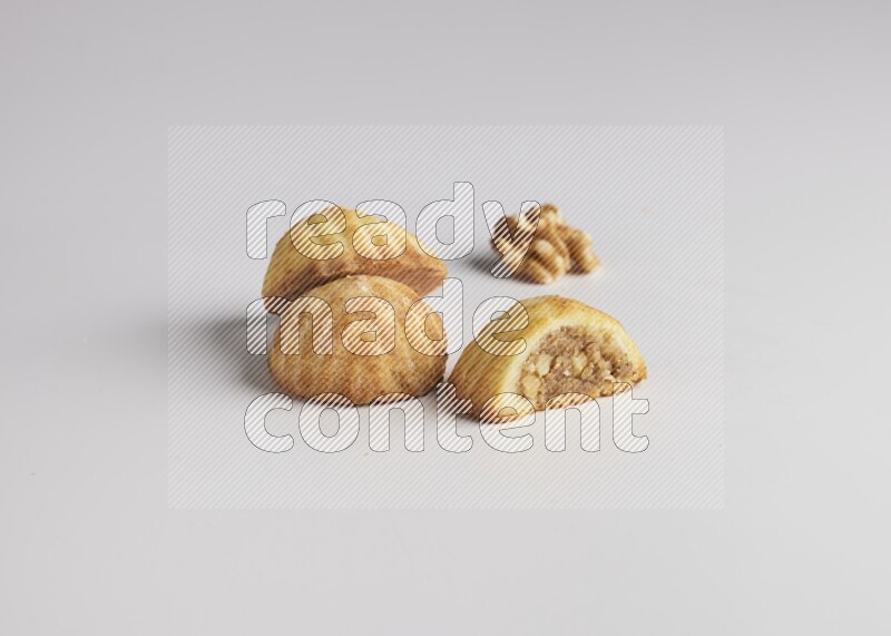 Three Pieces of Maamoul filled with walnut paste  one of them is cut direct on white background