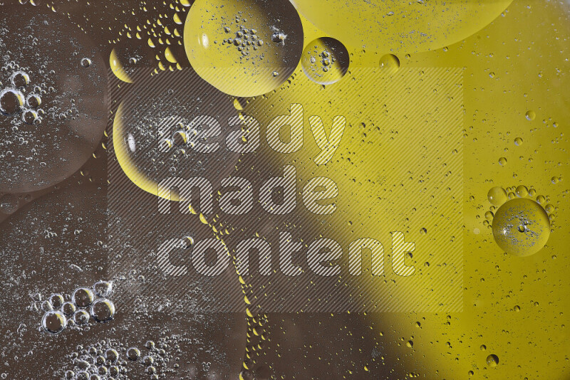 Close-ups of abstract oil bubbles on water surface in shades of yellow and brown