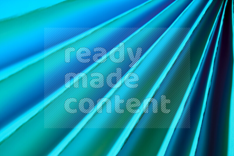 An image presenting an abstract paper pattern of lines in green and blue tones