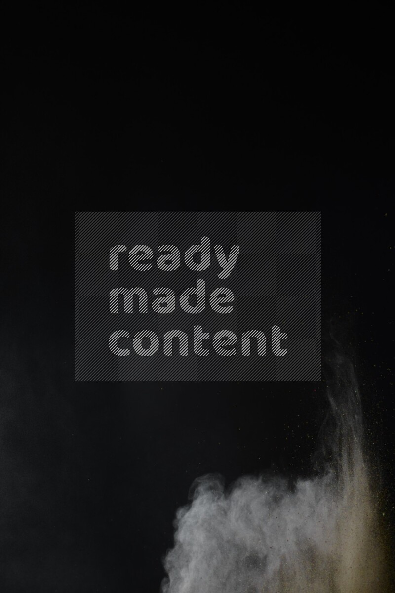 A side view of brown powder explosion on black background