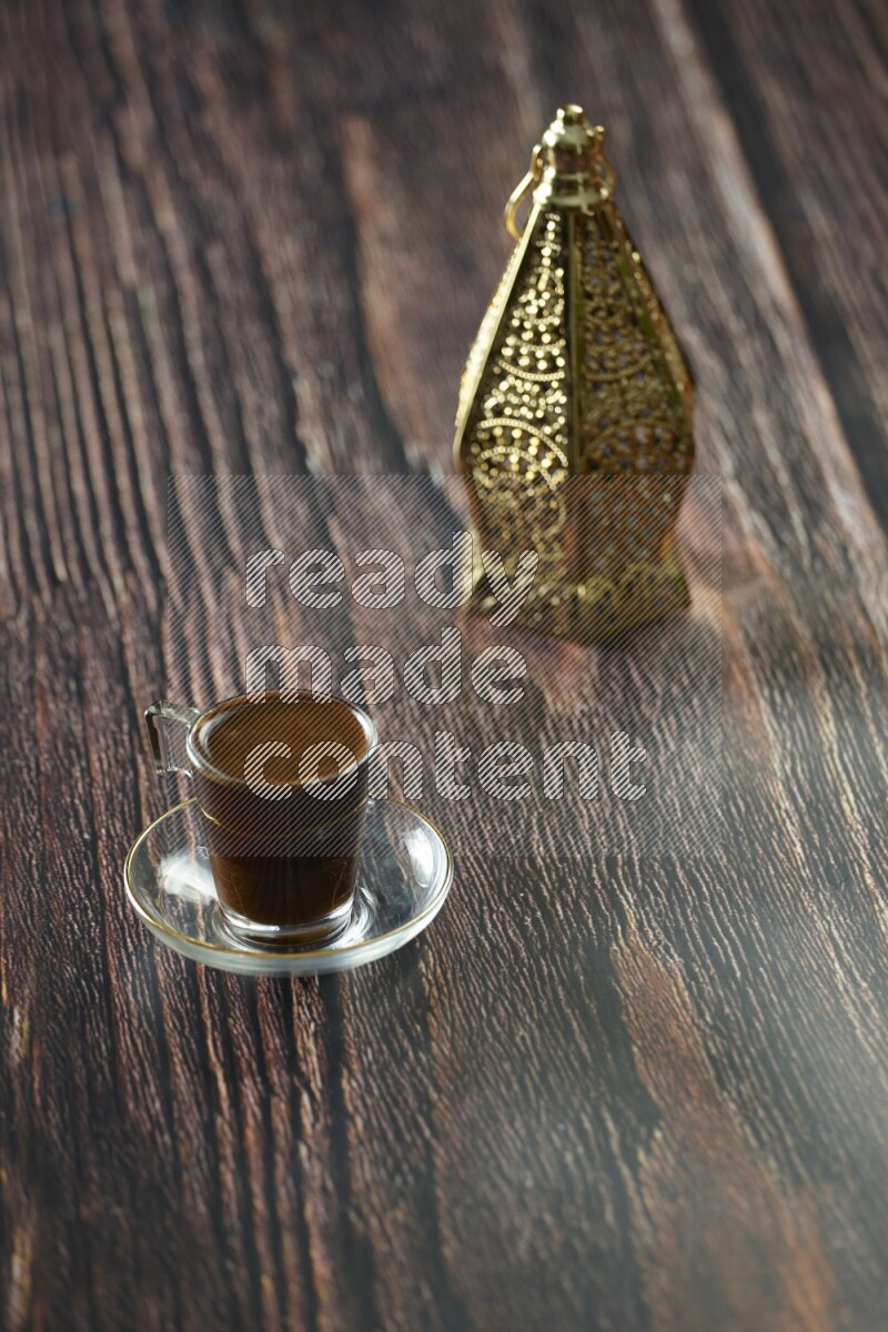 A golden lantern with different drinks, dates, nuts, prayer beads and quran on brown wooden background