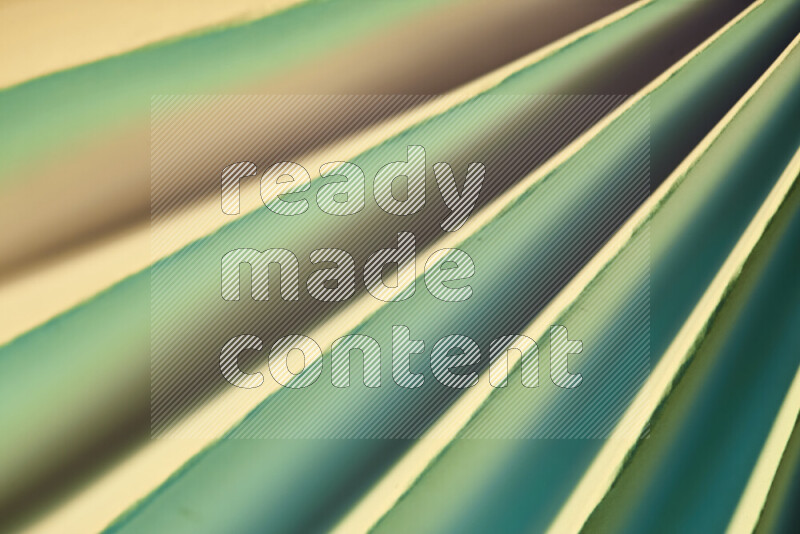 An image presenting an abstract paper pattern of lines in green and gold tones