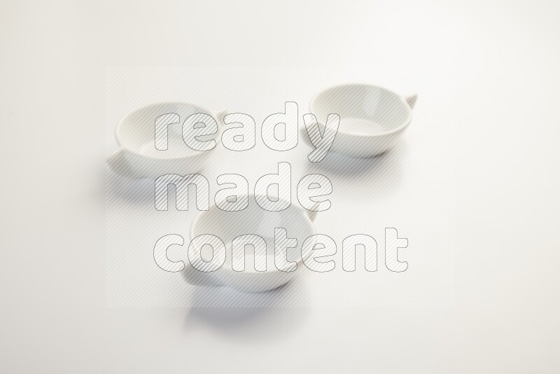 white ceramic round sauce dish on white countertop