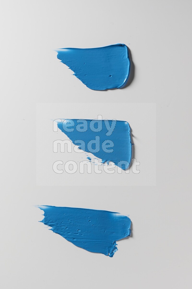 Blue painting knife strokes on a white background