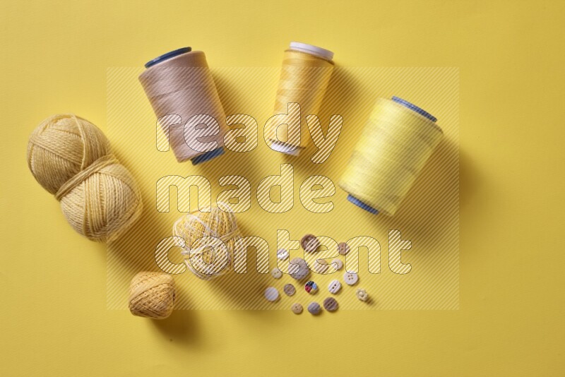 A yellow collection of sewing and tailoring tools arranged on a yellow background