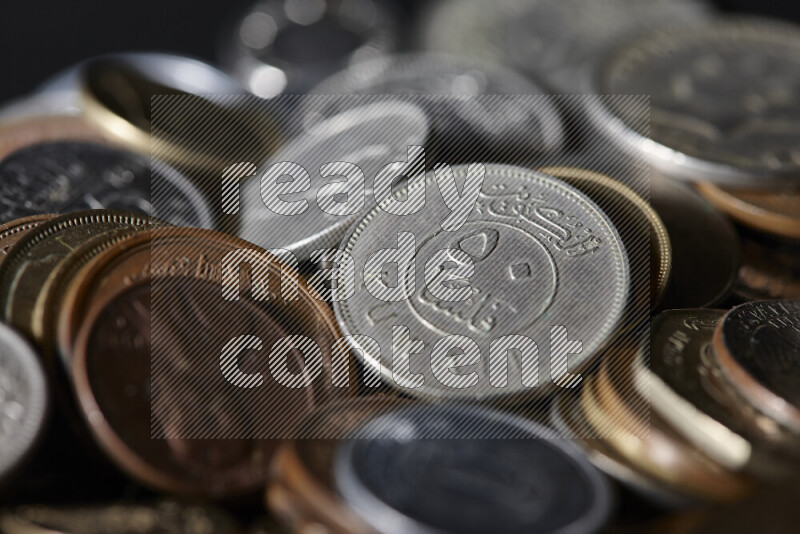 A close-ups of random old coins on black background