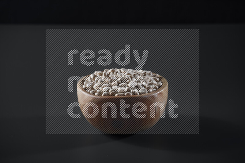 Lupin Beans in a wooden bowl on grey background