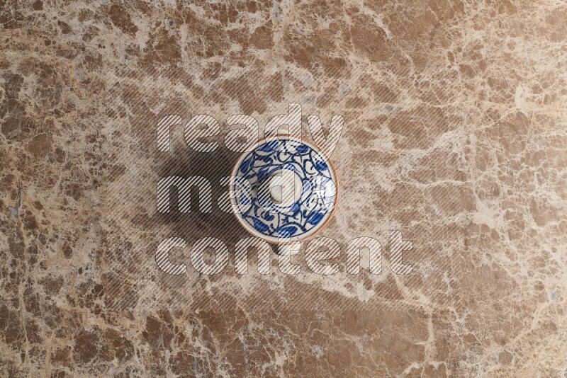 A multicolored pottery pot on beige marble background