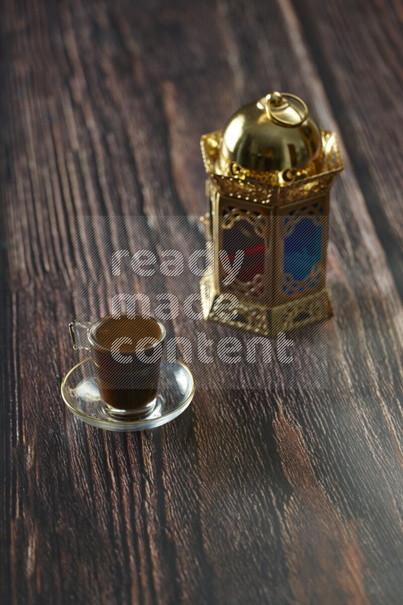 A golden lantern with different drinks, dates, nuts, prayer beads and quran on brown wooden background