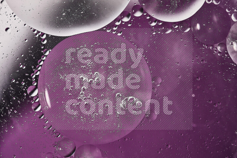 Close-ups of abstract oil bubbles on water surface in shades of white and purple