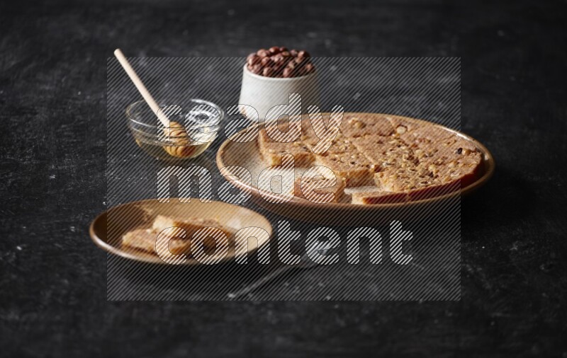 Basbousa with nuts and honey in a dark setup