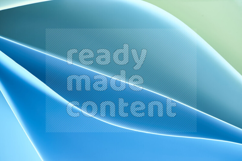 This image showcases an abstract paper art composition with paper curves in green and blue gradients created by colored light