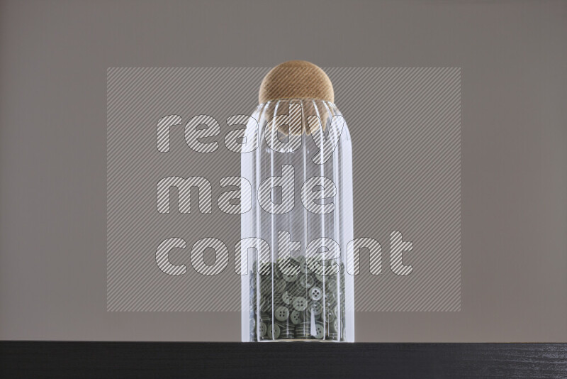 Buttons in a glass jar on black background