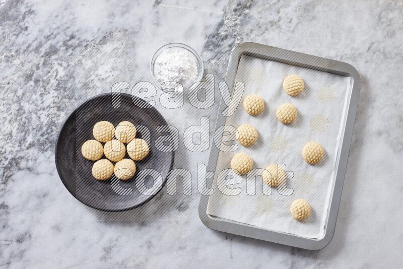 Kahk step by step with its ingredients ghee, sugar, flour, sesame, yeast, water and kahk flavor on grey marble background