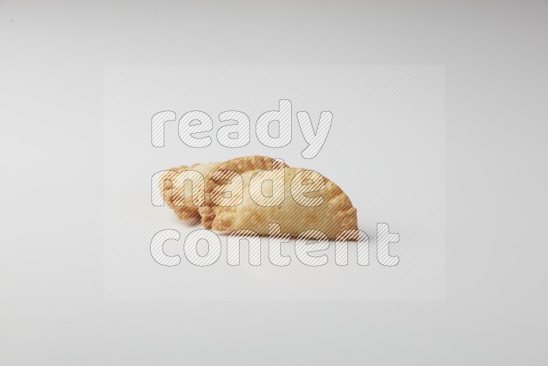 Three fried sambosas on a white background