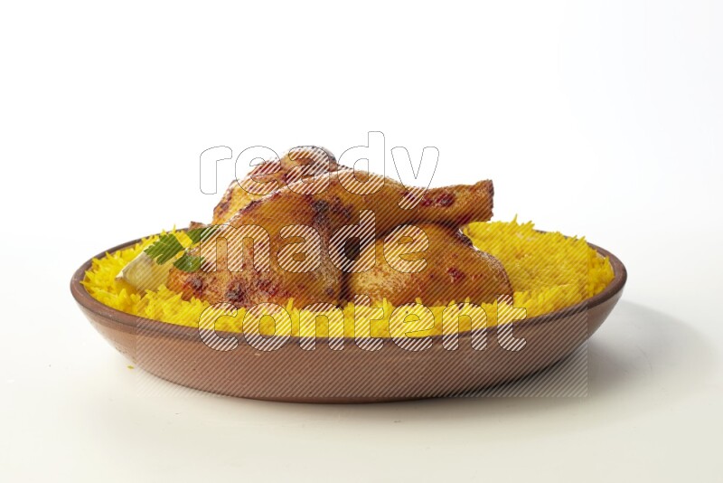 yellow basmati Rice with kabsa chicken pieces on a pottery plate direct on white background