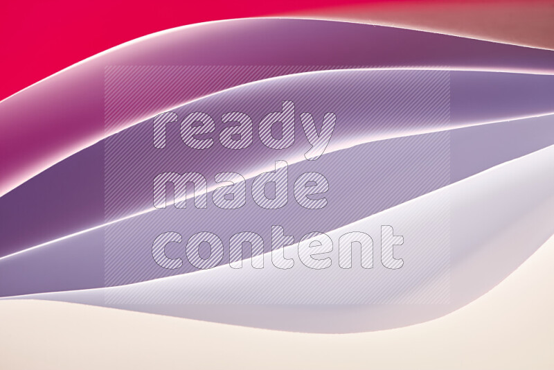 This image showcases an abstract paper art composition with paper curves in white and different warm gradients created by colored light