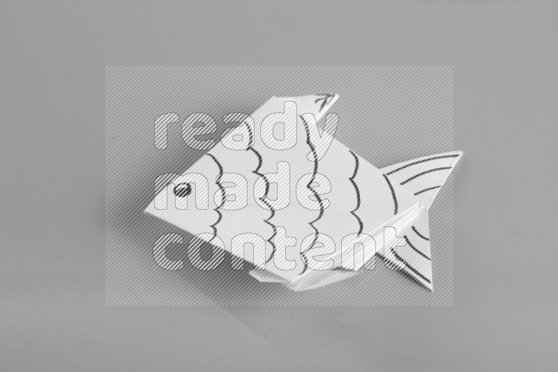 Origami fish on grey background