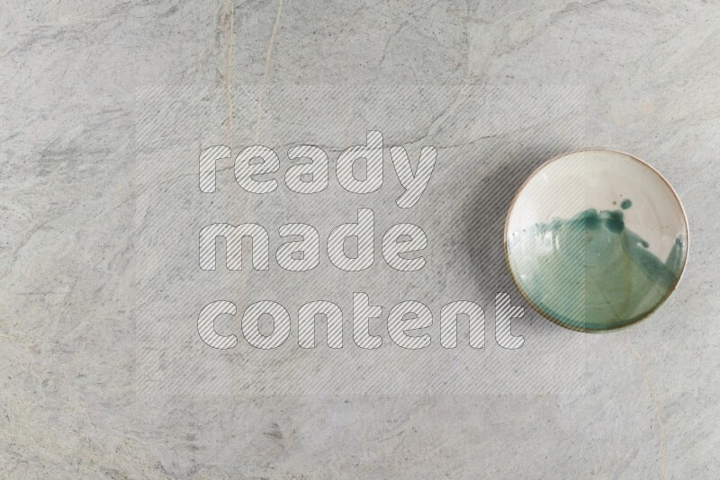 A multicolored pottery Bowl on grey marble background