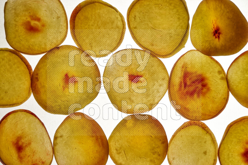 Peach slices on illuminated white background