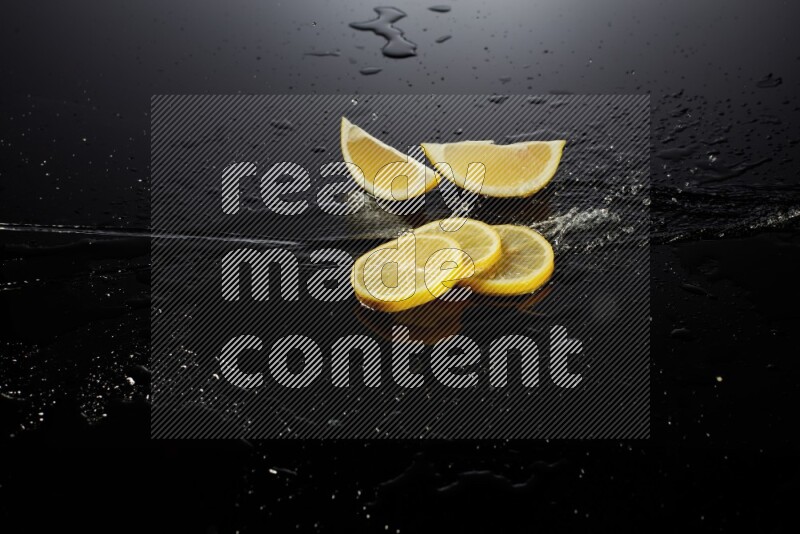 Lemon slices with water drops, and droplets on black background