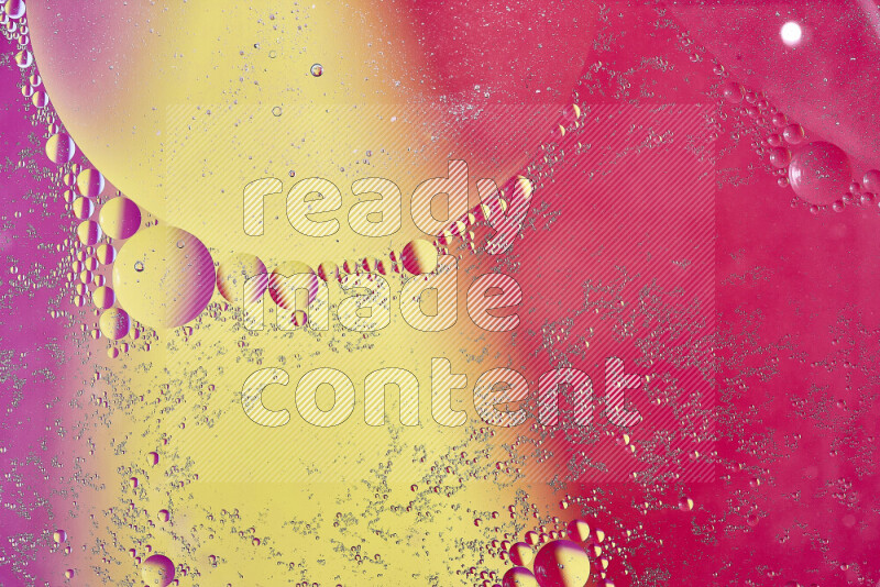 Close-ups of abstract oil bubbles on water surface in shades of yellow and pink