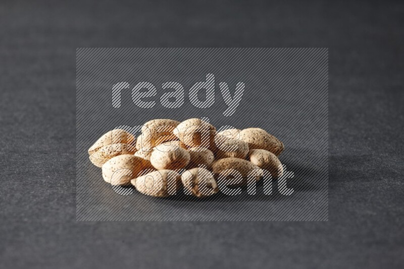 A bunch of almonds on a black background in different angles