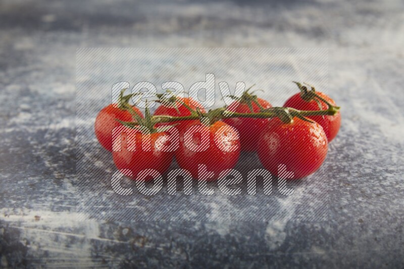 Red cherry tomato vein on a textured rusty blue background 45 degree