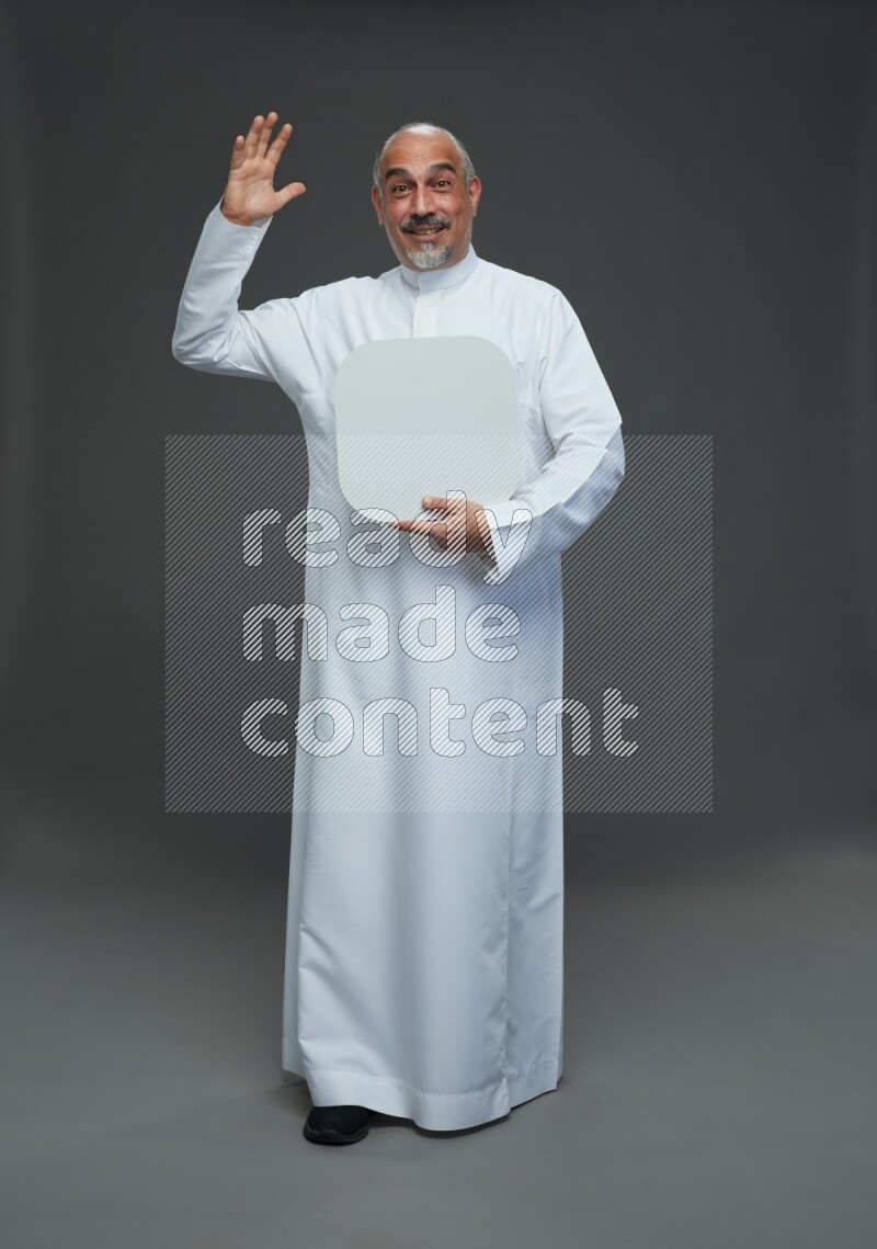 Saudi man without shomag Standing holding social media sing on gray background