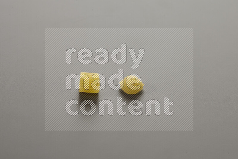 Big rings pasta with other types of pasta on grey background