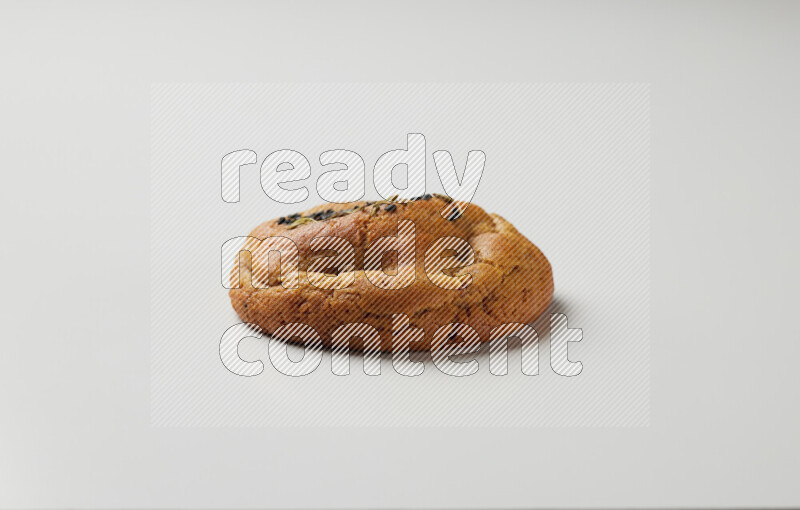 Hasawi cookie field with date and decorated by black seed and Anise grain on a white background