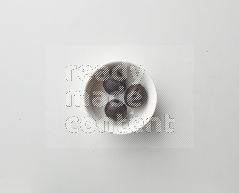 Top-view shot of dried lime (loomi) in a container on white background