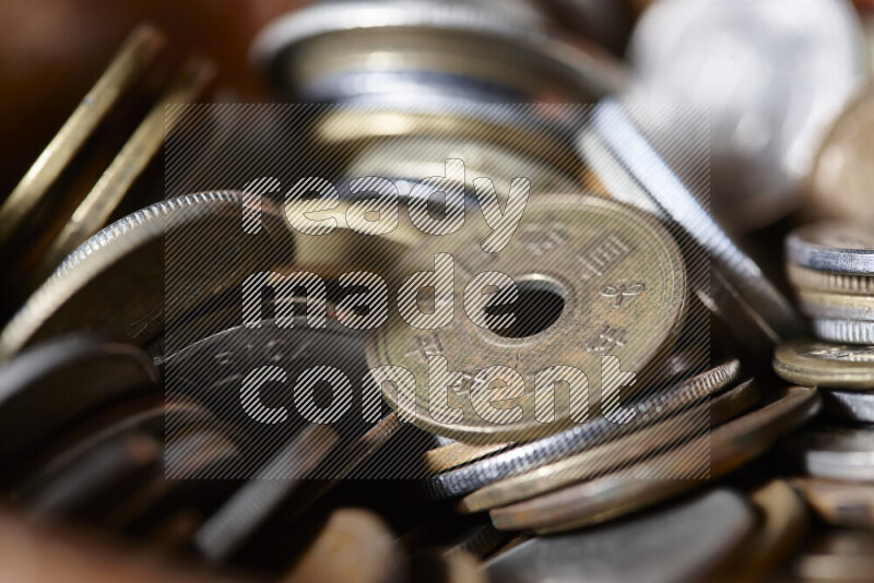 A close-ups of random old coins on black background