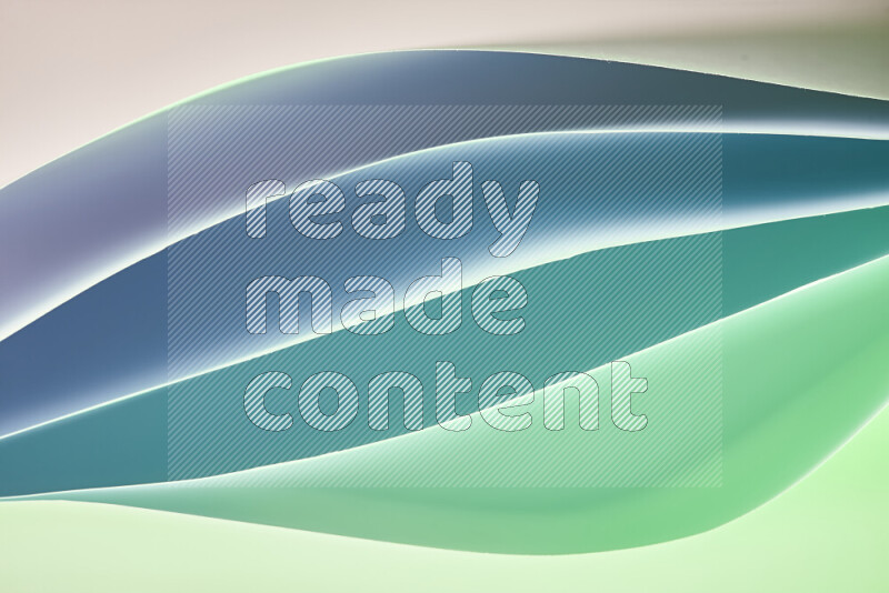 This image showcases an abstract paper art composition with paper curves in green and different warm gradients created by colored light